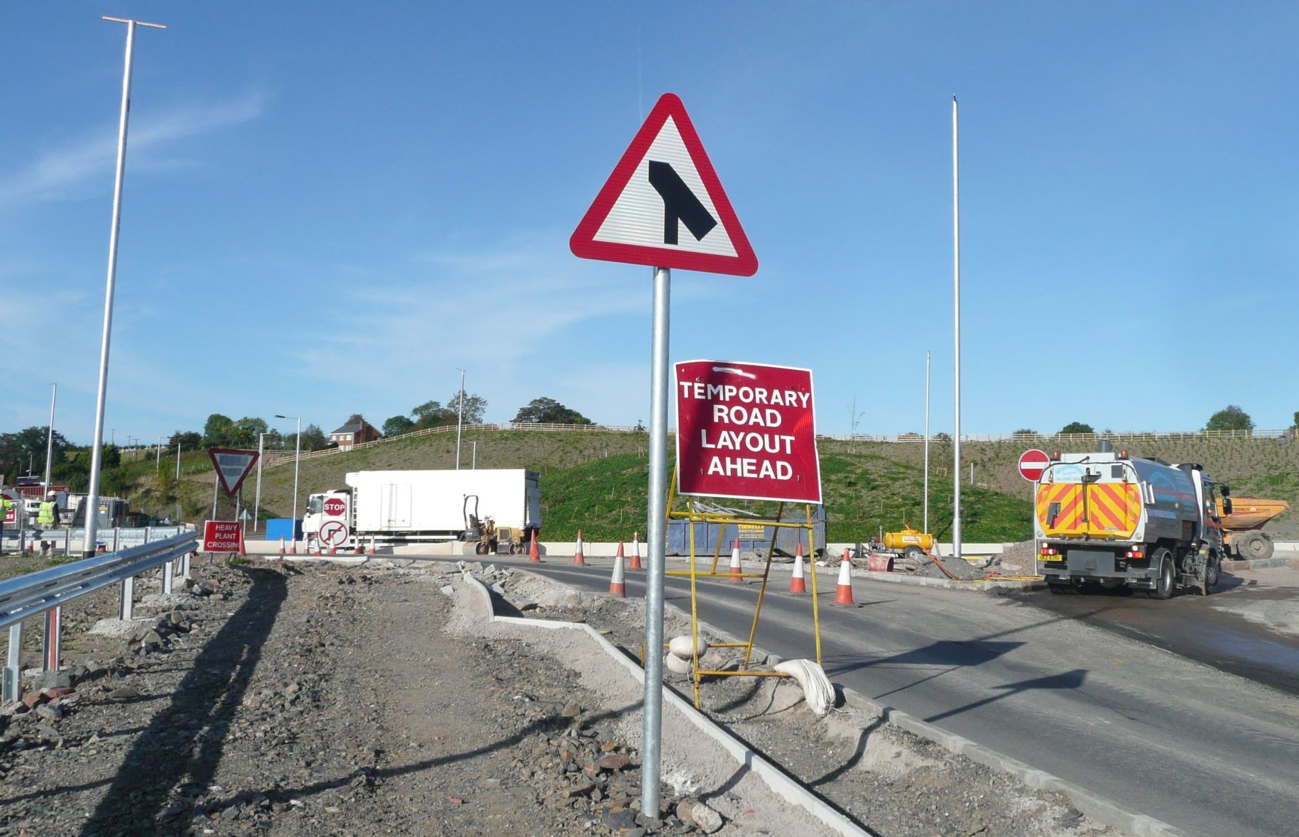Traffic management system with signs warning vehicles of a temporary road layout ahead.